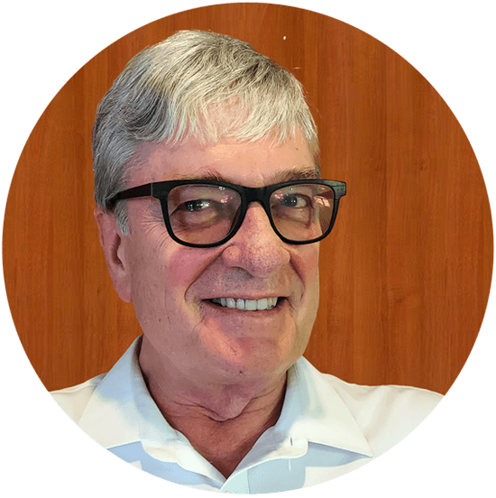 Senior man with glasses smiling, wooden background