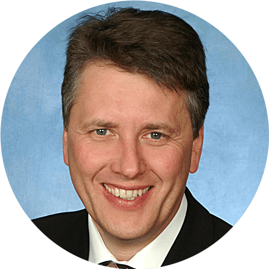 Smiling man in suit against blue circular background